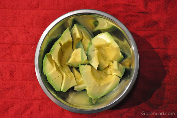 Sliced avocado on red towel Sliced avocado on red towel - Godmund