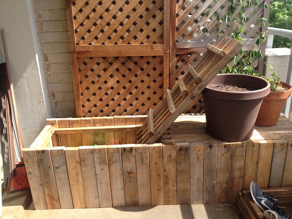 Image of bench on the porch, with one end of the bench top opened.